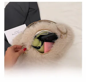 Spacious beige plush bucket bag interior showing capacity for phone and umbrella