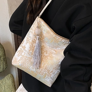 Embroidered butterfly bucket bag with gold jacquard landscape pattern and tassel charm