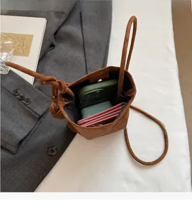 Top view of compact brown leather crossbody bag showing internal space for phone and cards