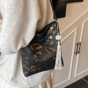 Chic black satin bucket bag with golden butterfly embroidery and floral tassel detail
