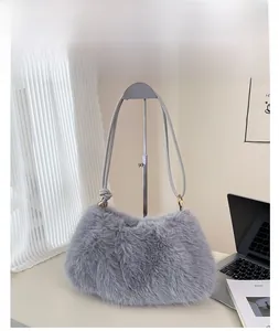 Detailed macro view of soft grey faux fur texture and knotted leather strap on bucket bag