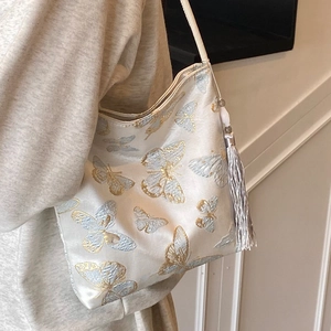 Elegant embroidered butterfly bucket bag with tassel detail for women's autumn style