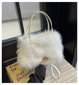 Detail of white faux fur tote bag showing fluffy texture and cream leather handles