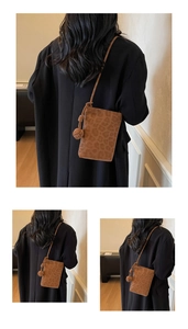 Close-up of leopard print phone bag in brown suede with decorative side knot detail