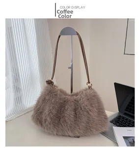 Detail of coffee brown fluffy faux fur bucket bag with leather strap on a display rack