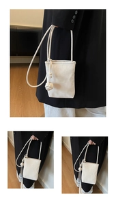 Detail of white minimalist mini phone pouch with round rope strap and knot detail