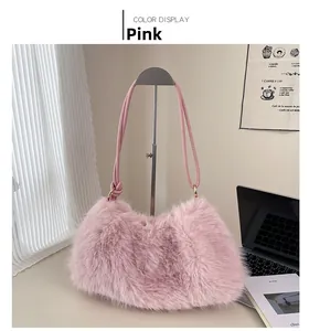 Close-up of pink faux fur bucket bag with a slim leather strap in a home office setting