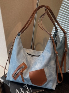 Large capacity denim canvas tote bag with brown leather accents and dual shoulder straps