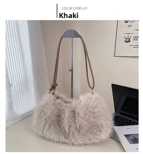 Detail of khaki faux fur bucket bag with leather strap and golden metal hardware