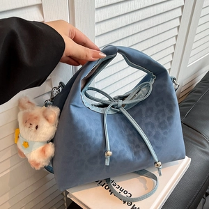 Blue leopard print pillow bag with bow detail and cute bear charm on shoulder strap