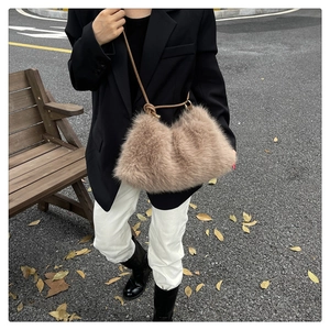 Detail of soft plush bucket bag in brown with adjustable knotted shoulder strap