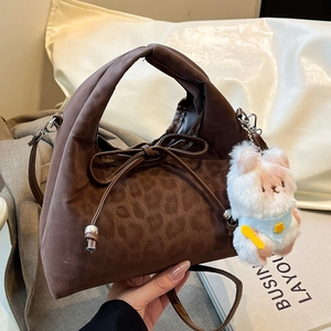 Brown leopard pattern pillow bag with plush rabbit charm and drawstring bow detail