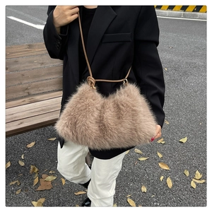 Chic beige faux fur bucket bag styled with leather straps in an autumn street setting