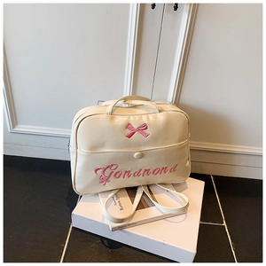 Detail of cream PU leather bag featuring delicate pink bow and artistic embroidery