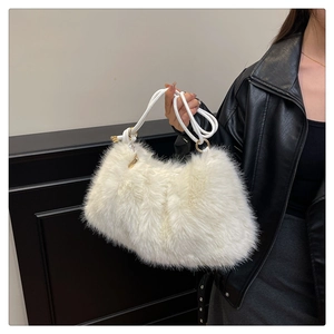 Macro detail of soft white faux fur handbag with twisted rope handle and gold rings