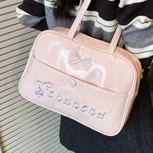 Pink glossy faux leather shoulder bag with embroidered bow and lettering on the front