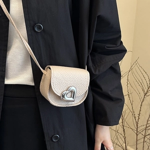 Minimalist beige pebble leather mini crossbody bag with silver heart-shaped lock buckle