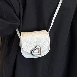 White lychee pattern mini crossbody bag with silver heart buckle on black clothing