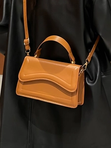 Caramel brown PU leather handbag with wave flap and adjustable strap for women