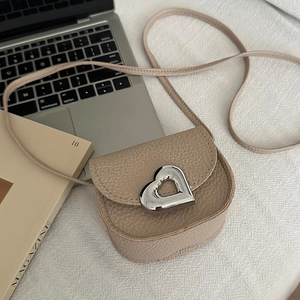 Chic beige crossbody square bag with heart lock and pebble leather texture on desktop