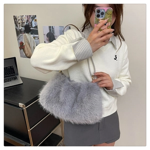 Detailed close-up of a grey plush faux fur bucket bag with a soft pleated texture