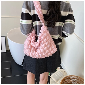Detail of pink bubble fabric shoulder bag showing textured material and large capacity