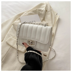 Detail of white quilted chain bag featuring a luxury crystal-encrusted metal lock