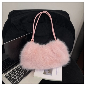 Detail of pink faux fur bucket bag texture with slim straps on autumn fashion accessory