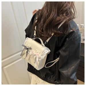 Close-up of white Lolita style backpack with lace edges and heart embossed details