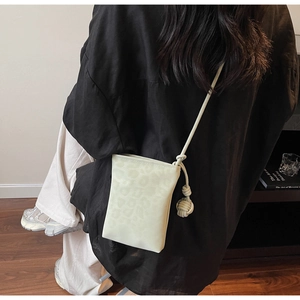 Detail of leopard print mini crossbody bag with knot shoulder strap on casual outfit