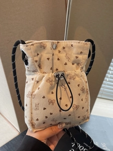 Beige corduroy crossbody bag with heart bow prints and woven rope strap for women