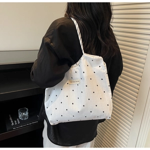 Gros plan d'un grand sac cabas en mousseline à fleurs avec motifs d'étoiles épurés