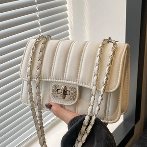 Quilted cream chain crossbody bag with silver rhinestone twist lock in soft PU leather