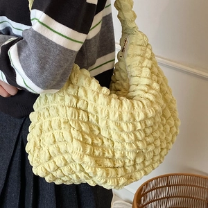 Fashionable pale yellow popcorn texture hobo bag worn by model with large capacity style
