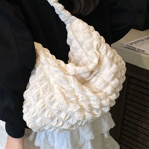 Minimalist cream bubble textured underarm shoulder bag for women shown on model