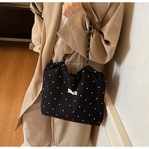 Détail du sac cabas noir en mousseline à motif floral et poignées en corde tressée