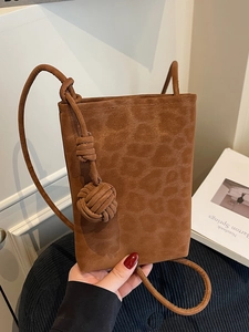 Brown faux suede leopard texture crossbody bag with stylish knot strap and tassel