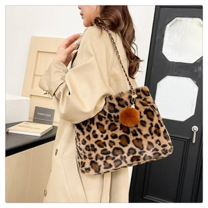 Detail showing the leopard print faux fur texture and metal chain strap of the shoulder bag