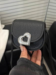 Black mini crossbody saddle bag with silver heart buckle and lychee leather texture