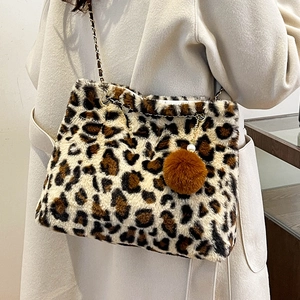 Faux fur leopard print shoulder bag with metal chain strap and plush ball charm accessory