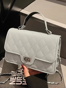 Quilted light blue leather crossbody bag with silver chain strap and top handle