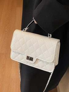 White quilted chain shoulder bag with silver turn-lock and elegant top handle for women
