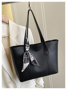 Close-up of black tote bag featuring premium matte texture and decorative printed scarf
