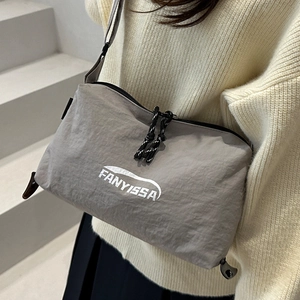 Minimalist grey nylon crossbody bag with FANYISSA logo and adjustable woven strap