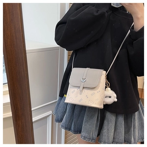 Mini crossbody bag with grey flap and cartoon cat print shown in a mirror selfie