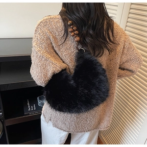Détail du sac à bandoulière en fausse fourrure noire avec sangle en perles de bois