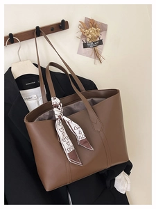 Brown large capacity tote bag with decorative bear print scarf on a wooden hanger
