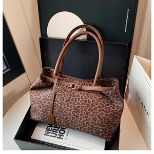 Macro shot of large leopard print tote bag with brown leather handles in a gift box set