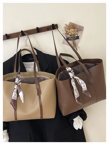 Detail of large PU leather tote bags with printed silk scarves and contrasting straps