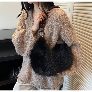 Détail du sac croissant en fausse fourrure noire avec bandoulière en perles de bois